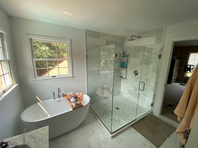 Finished bathroom with freestanding tub and glass shower