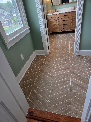 Finished herringbone bathroom tile floor